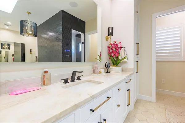 a bathroom with a double vanity sink toilet and a mirror