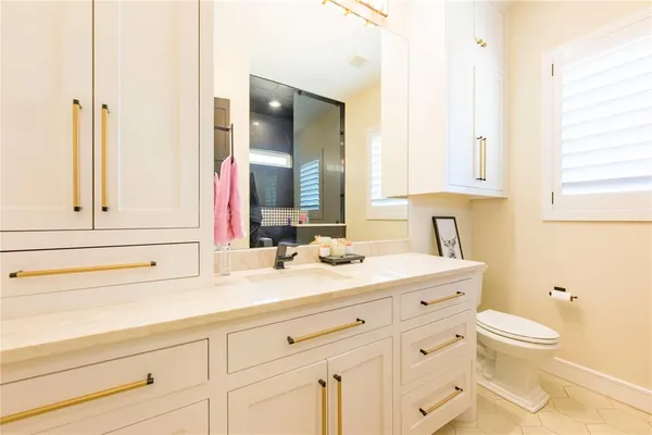 a spacious bathroom with a granite countertop sink and a mirror
