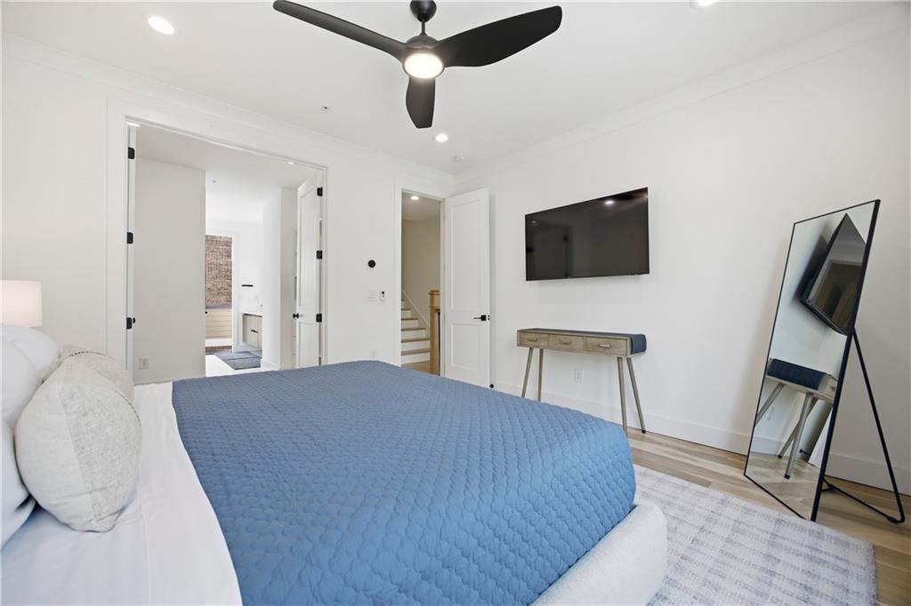 Undisclosed Address Atlanta, GA 30313 - Photo 16 of 35 a bedroom with a bed a flat screen tv and a chair