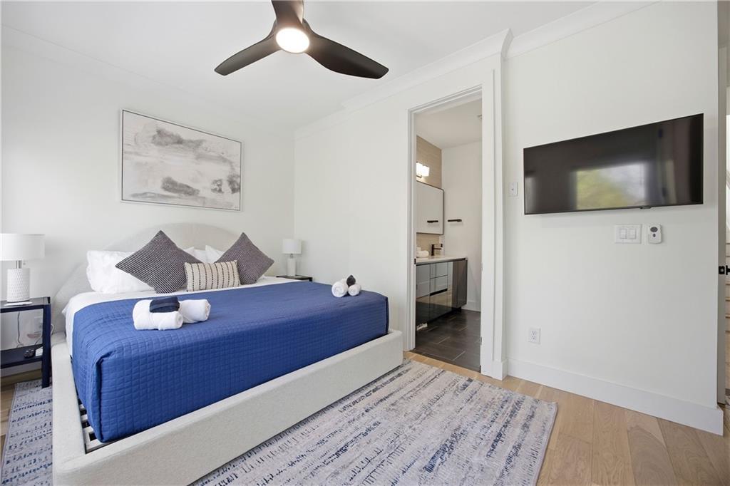 Undisclosed Address Atlanta, GA 30313 - Photo 22 of 35 a bedroom with a bed and a flat screen tv