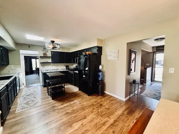 a living room with stainless steel appliances furniture a kitchen view and living room view