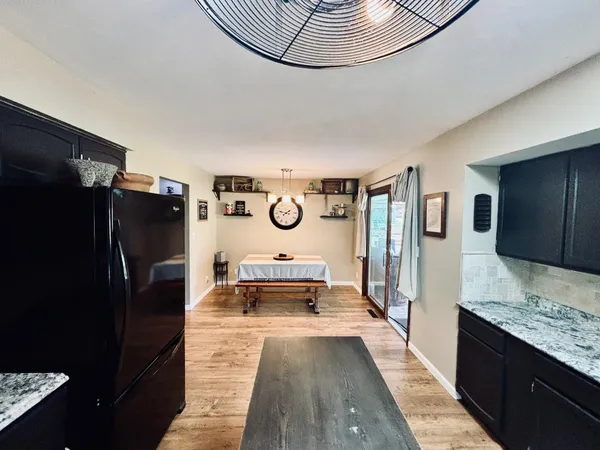 a kitchen with stainless steel appliances granite countertop a refrigerator and a sink
