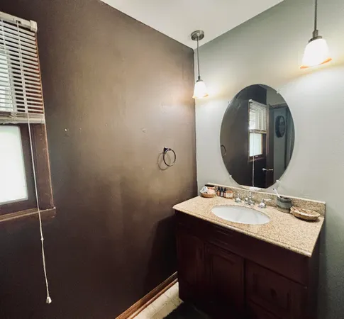 a bathroom with a sink mirror and vanity