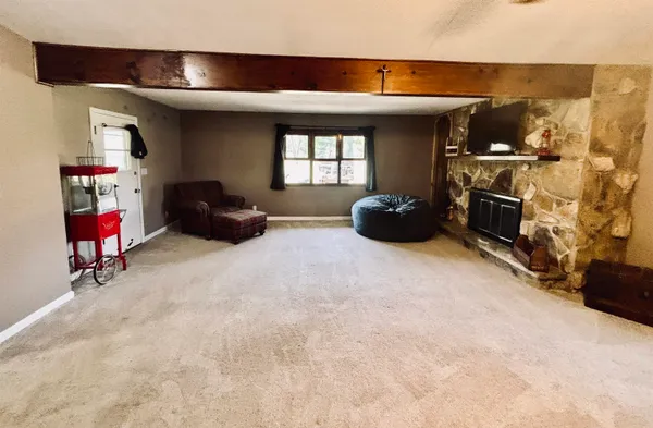 a living room with furniture and a air conditioner vent