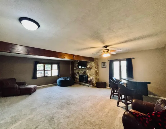 a view of a livingroom with furniture and a gym