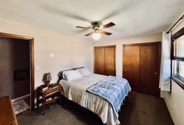 a bedroom with a bed and a chandelier