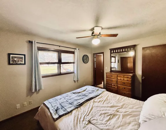 a bedroom with a large bed and a tv