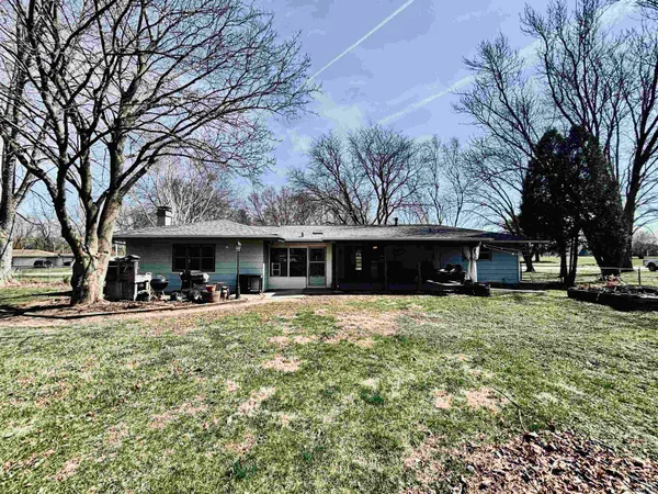 a view of a house with a yard covered in snow