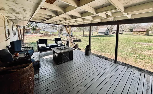 a living room with lots of furniture and wooden floor