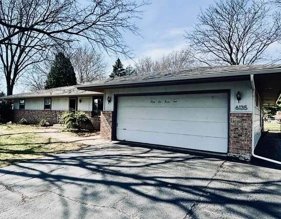 a view of a house with a yard covered with snow in the outdoor space