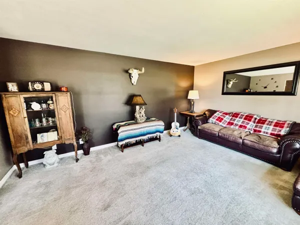 a living room with furniture and gym equipment