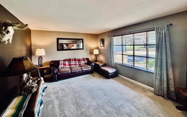 a bedroom with furniture and a window