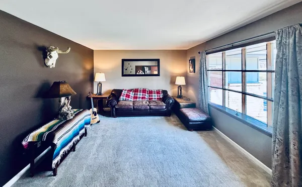 a living room with furniture gym equipment and a large window