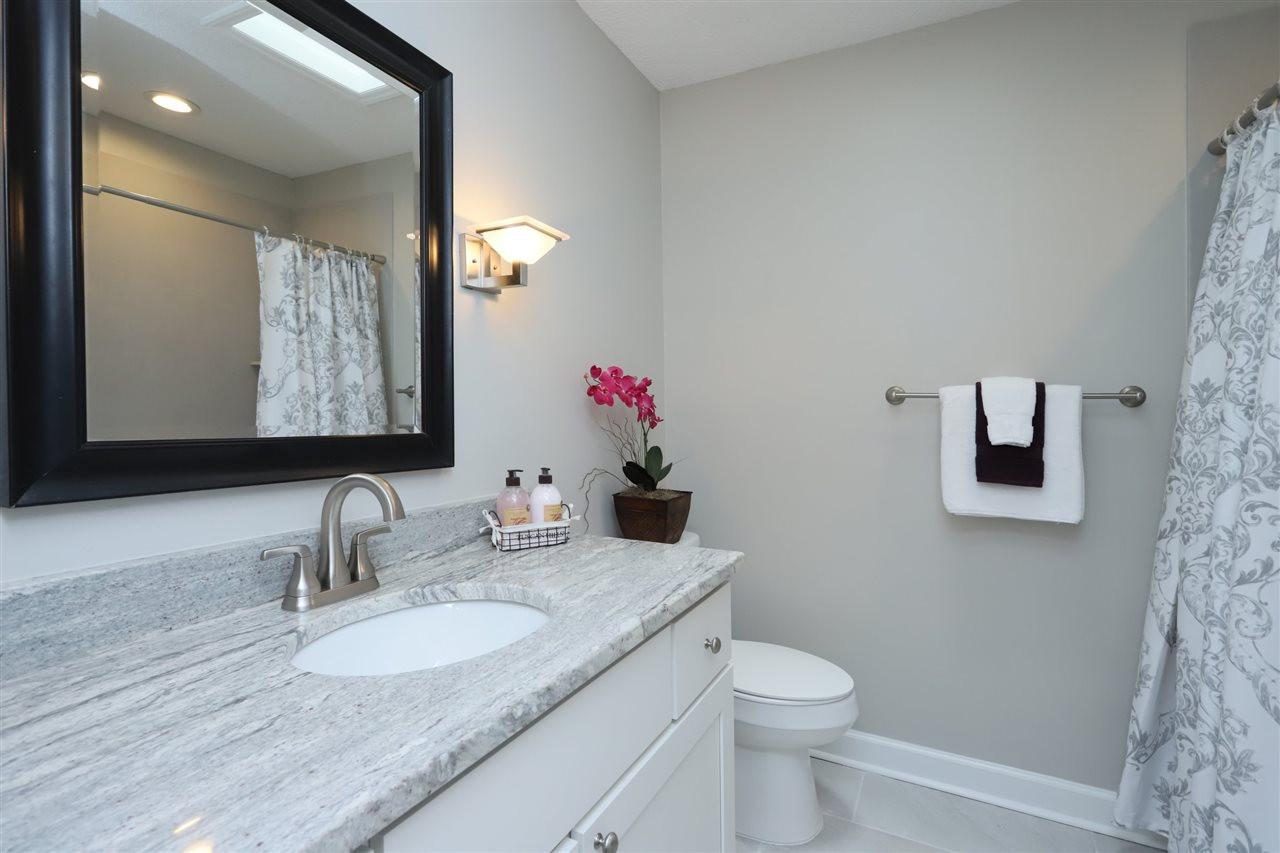 4101 Stranaver Place Raleigh, NC 27612 - Photo 21 of 27 Hall bath has been updated with granite vanity top and ceramic tub surround. Bathroom