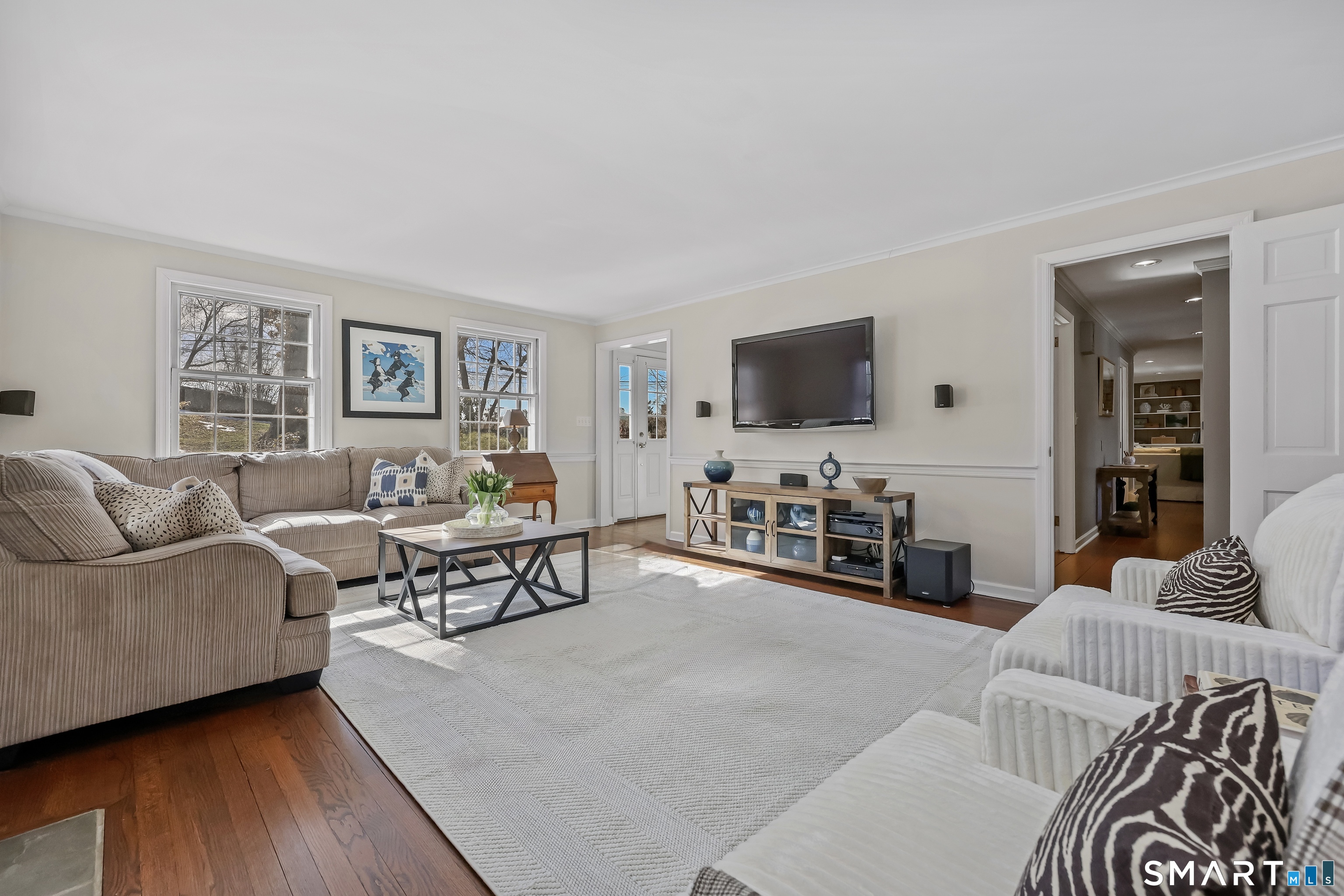 610 Unquowa Road Fairfield, CT 06824 - Photo 14 of 43 a living room with furniture and a flat screen tv with kitchen view