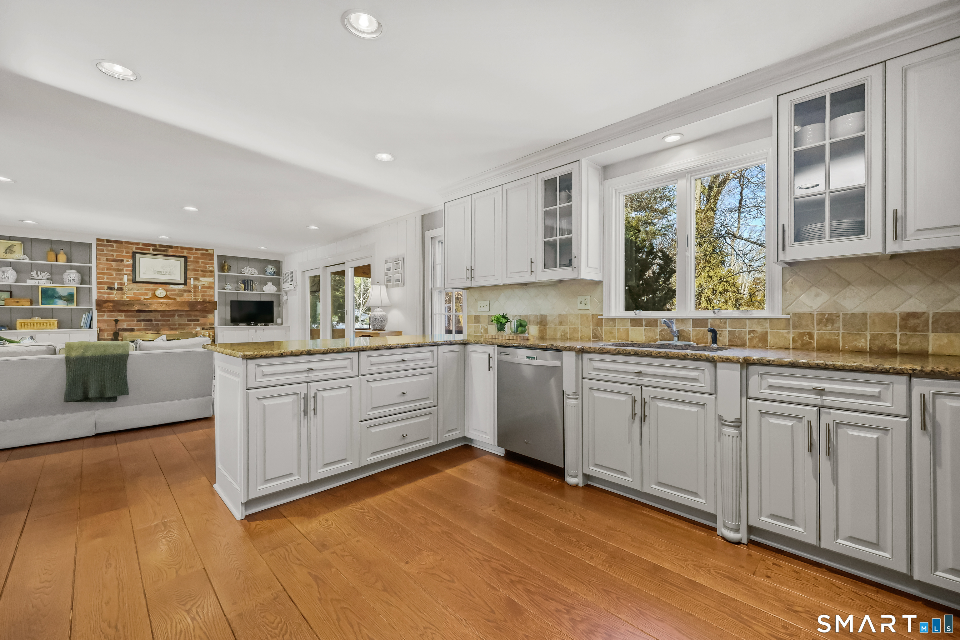 610 Unquowa Road Fairfield, CT 06824 - Photo 15 of 43 a kitchen with granite countertop white cabinets and white appliances