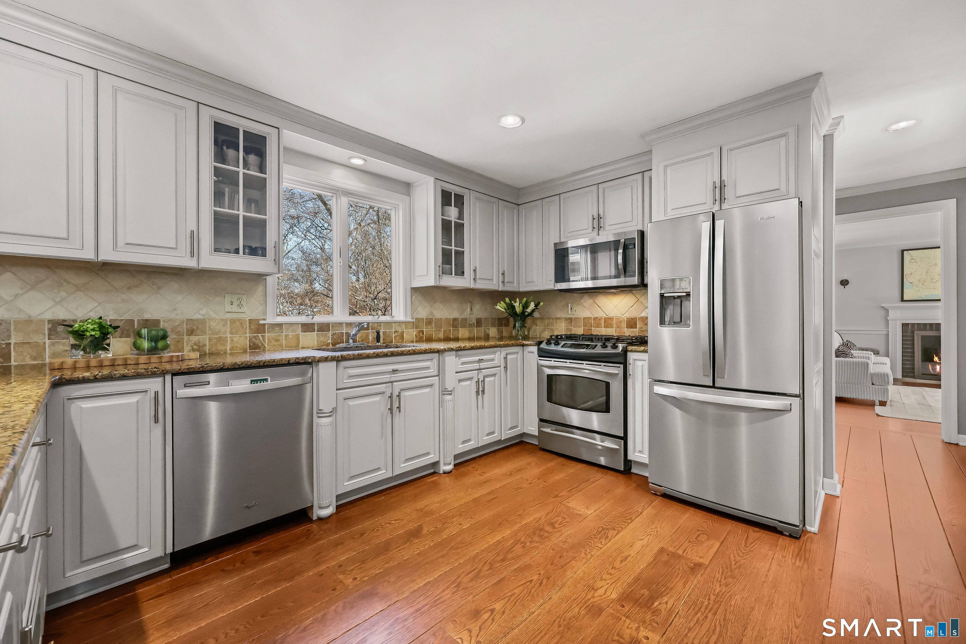 610 Unquowa Road Fairfield, CT 06824 - Photo 17 of 43 a kitchen with granite countertop stainless steel appliances a sink and refrigerator