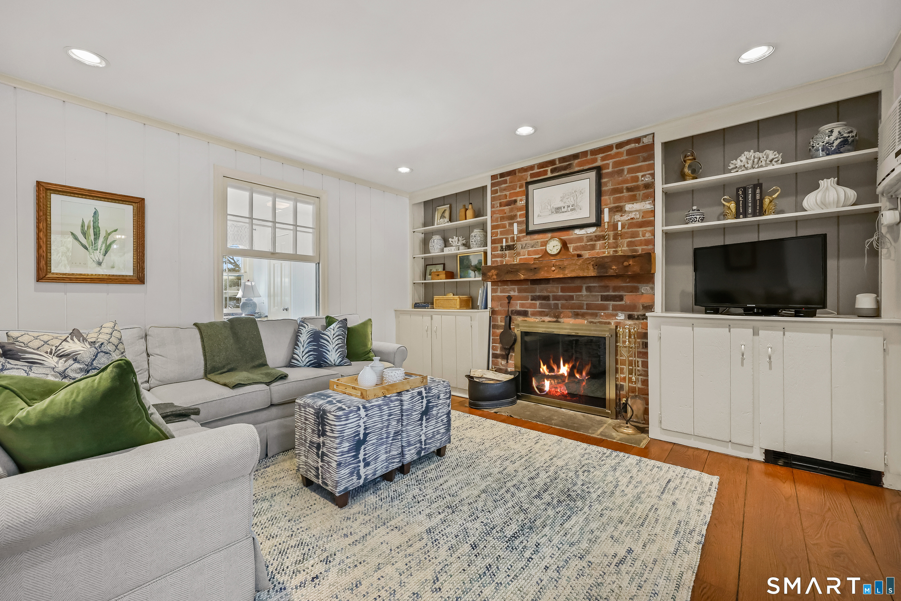 610 Unquowa Road Fairfield, CT 06824 - Photo 20 of 43 a living room with furniture and a fireplace