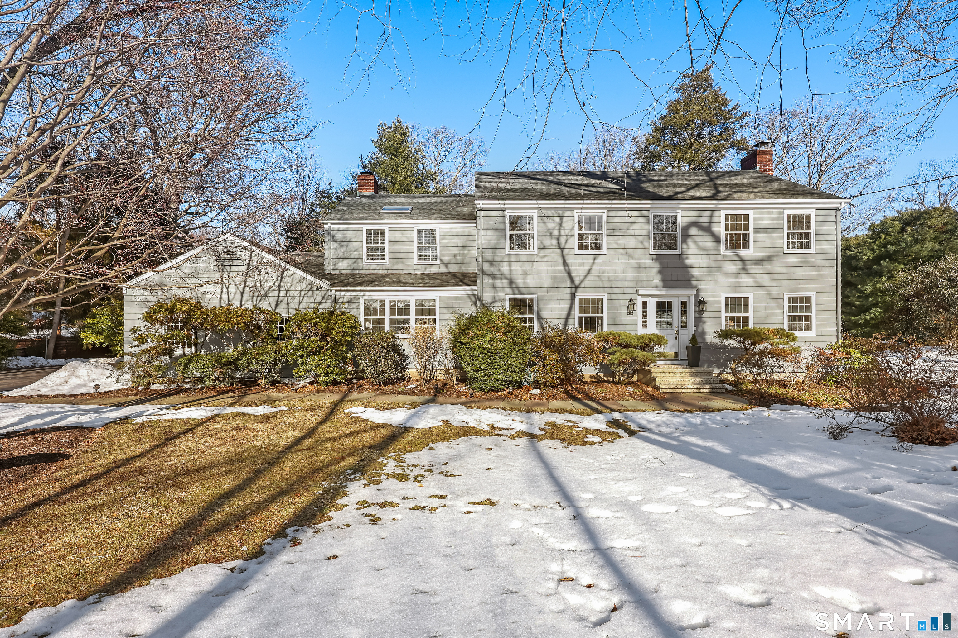 610 Unquowa Road Fairfield, CT 06824 - Photo 2 of 43 a view of a brick house with many windows next to a road