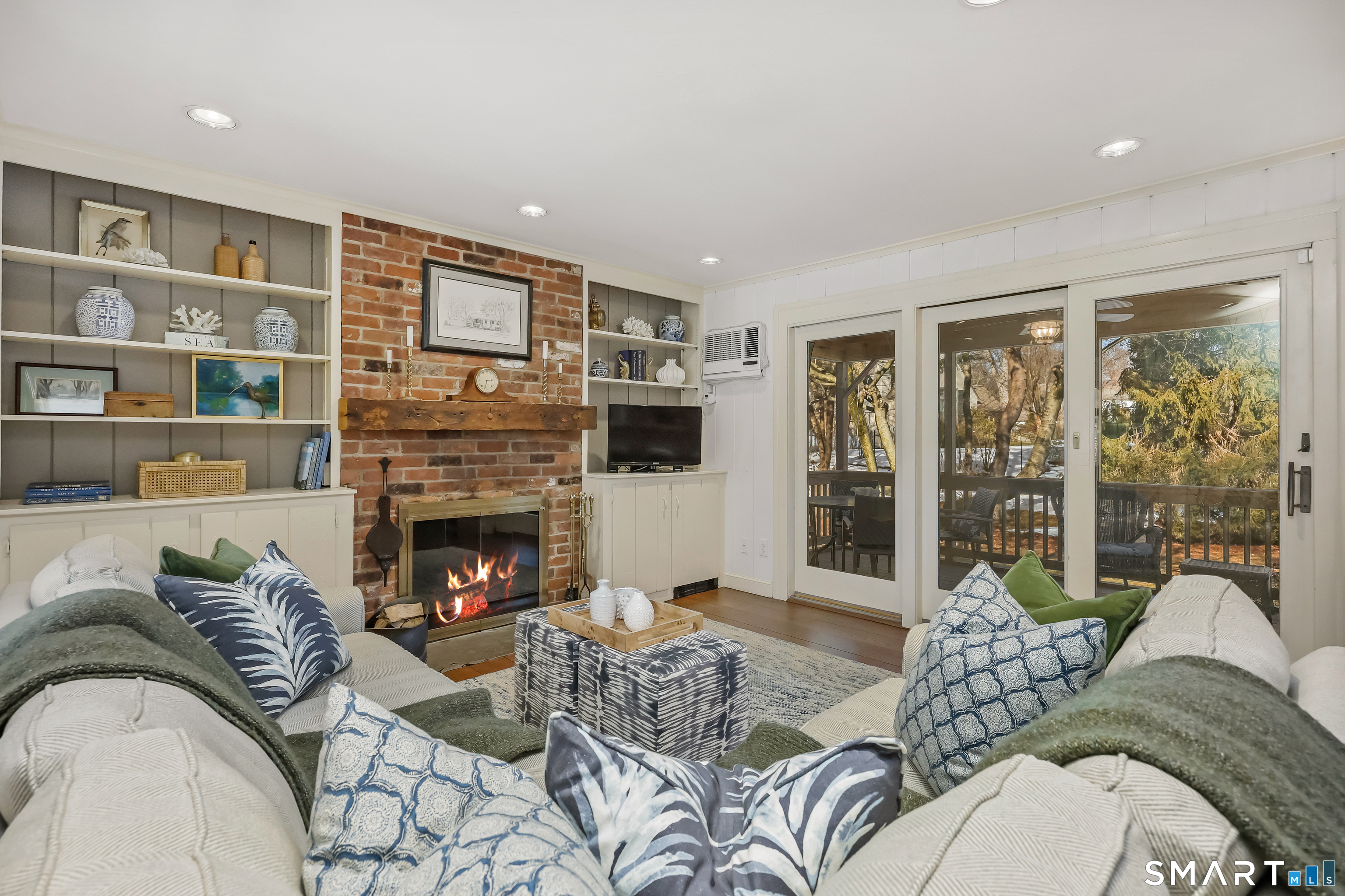 610 Unquowa Road Fairfield, CT 06824 - Photo 21 of 43 a living room with furniture fireplace and large window