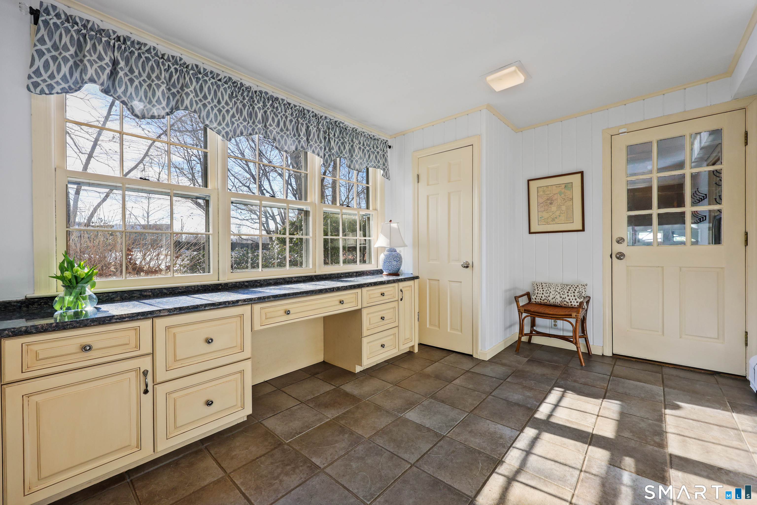 610 Unquowa Road Fairfield, CT 06824 - Photo 27 of 43 a large white kitchen with granite countertop a large window