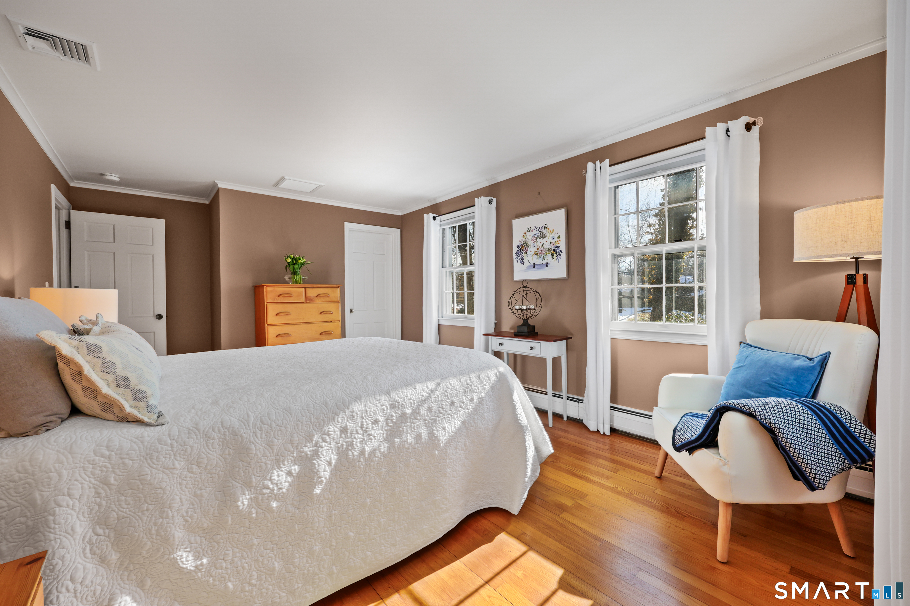 610 Unquowa Road Fairfield, CT 06824 - Photo 31 of 43 a bedroom with a bed and wooden floor