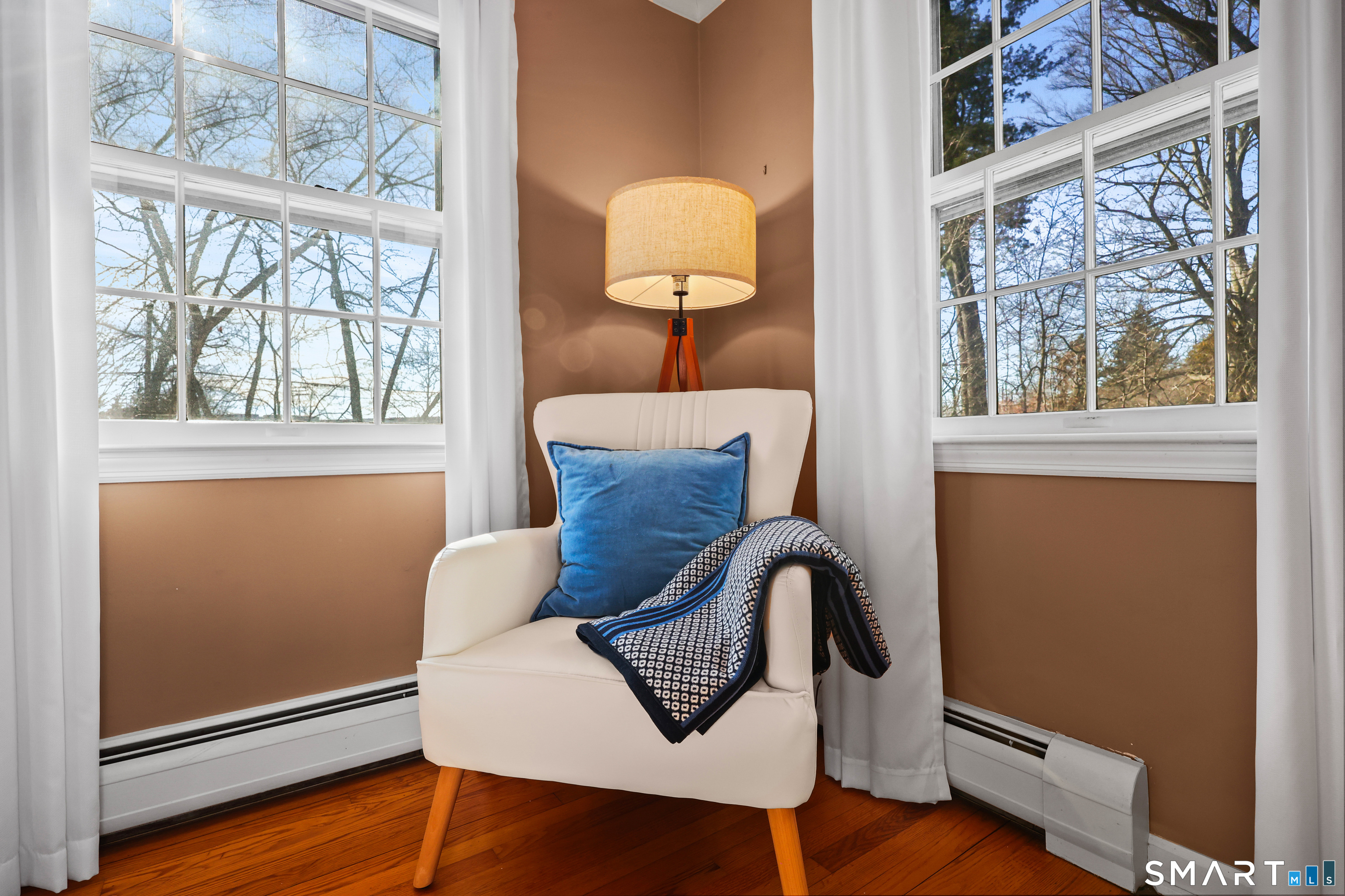 610 Unquowa Road Fairfield, CT 06824 - Photo 33 of 43 a view of table and chair with potted plant next to a window