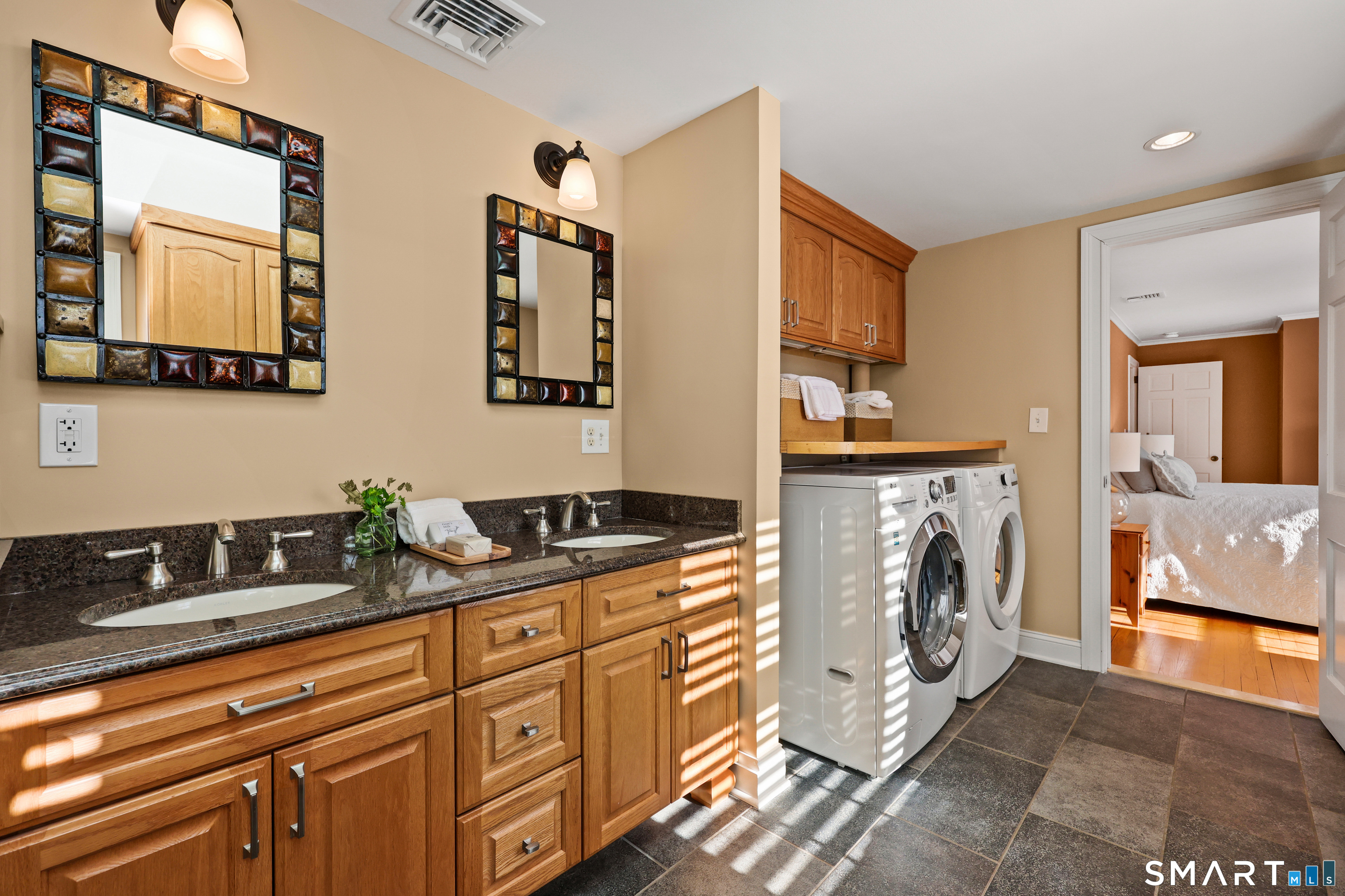610 Unquowa Road Fairfield, CT 06824 - Photo 34 of 43 a spacious bathroom with a double vanity sink and a mirror