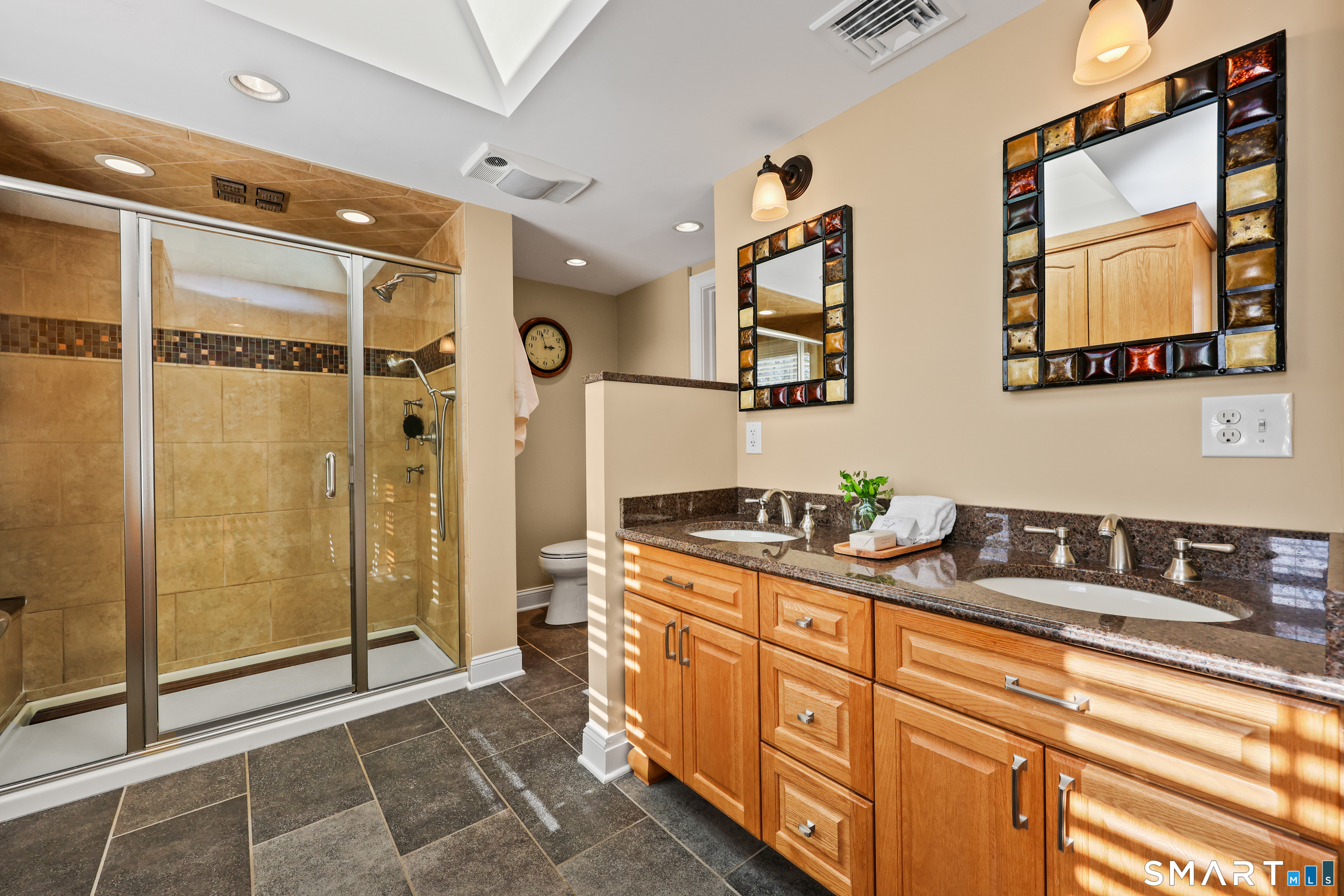 610 Unquowa Road Fairfield, CT 06824 - Photo 35 of 43 a spacious bathroom with a mirror a shower sink and