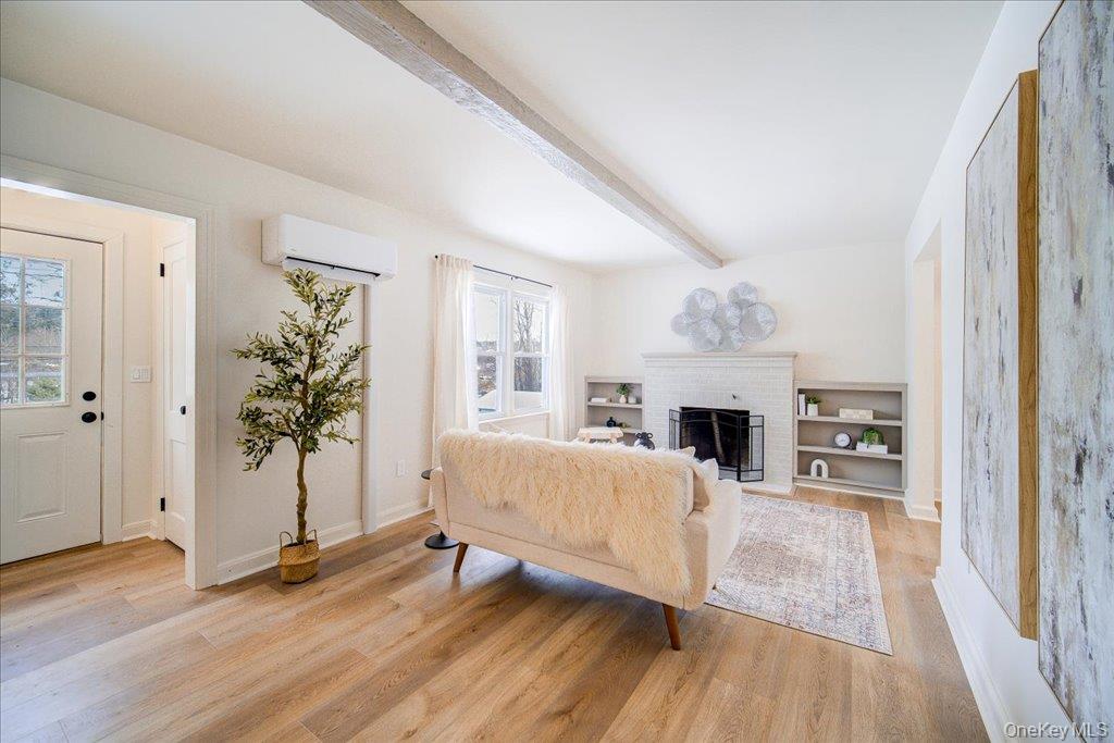 392 Titusville Road Poughkeepsie, NY 12603 - Photo 11 of 43 a view of a livingroom with a fireplace wooden floor and staircase