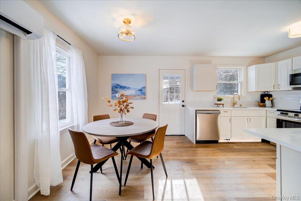 392 Titusville Road Poughkeepsie, NY 12603 - Photo 14 of 43 a view of a dining room with furniture and a kitchen