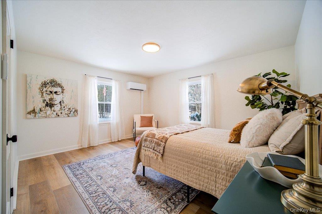 392 Titusville Road Poughkeepsie, NY 12603 - Photo 23 of 43 a bedroom with a bed and wooden floor