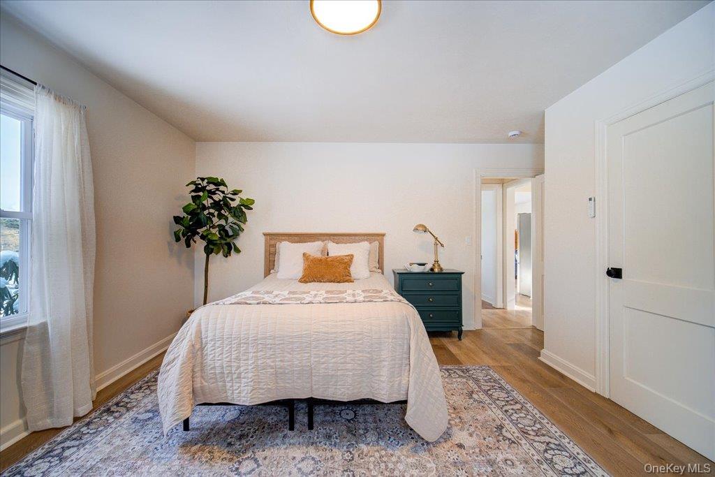 392 Titusville Road Poughkeepsie, NY 12603 - Photo 24 of 43 a bedroom with a bed and a potted plant