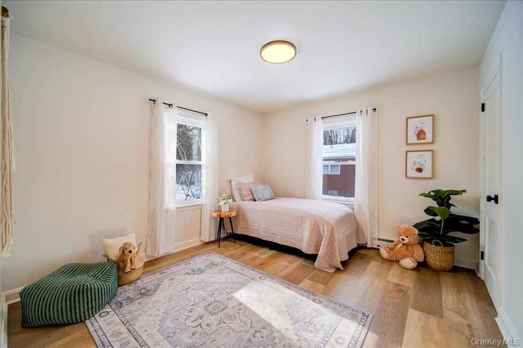 392 Titusville Road Poughkeepsie, NY 12603 - Photo 26 of 43 a bedroom with a bed and a couch