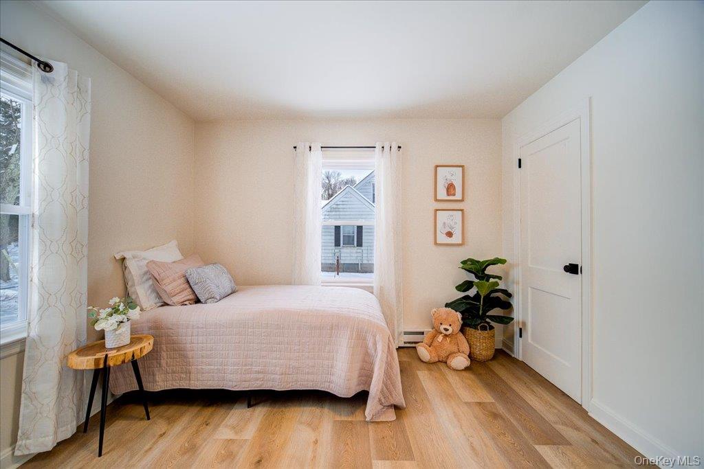 392 Titusville Road Poughkeepsie, NY 12603 - Photo 27 of 43 a bedroom with a bed and wooden floor
