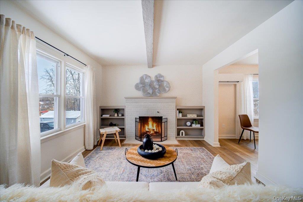 392 Titusville Road Poughkeepsie, NY 12603 - Photo 9 of 43 a living room with furniture a window and a fireplace