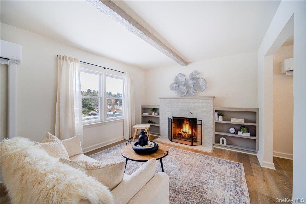 392 Titusville Road Poughkeepsie, NY 12603 - Photo 10 of 43 a living room with furniture and a fireplace