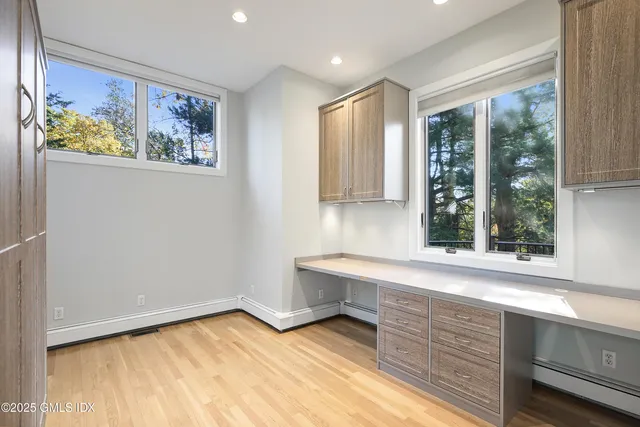 a view of a kitchen with wooden floor and outdoor space