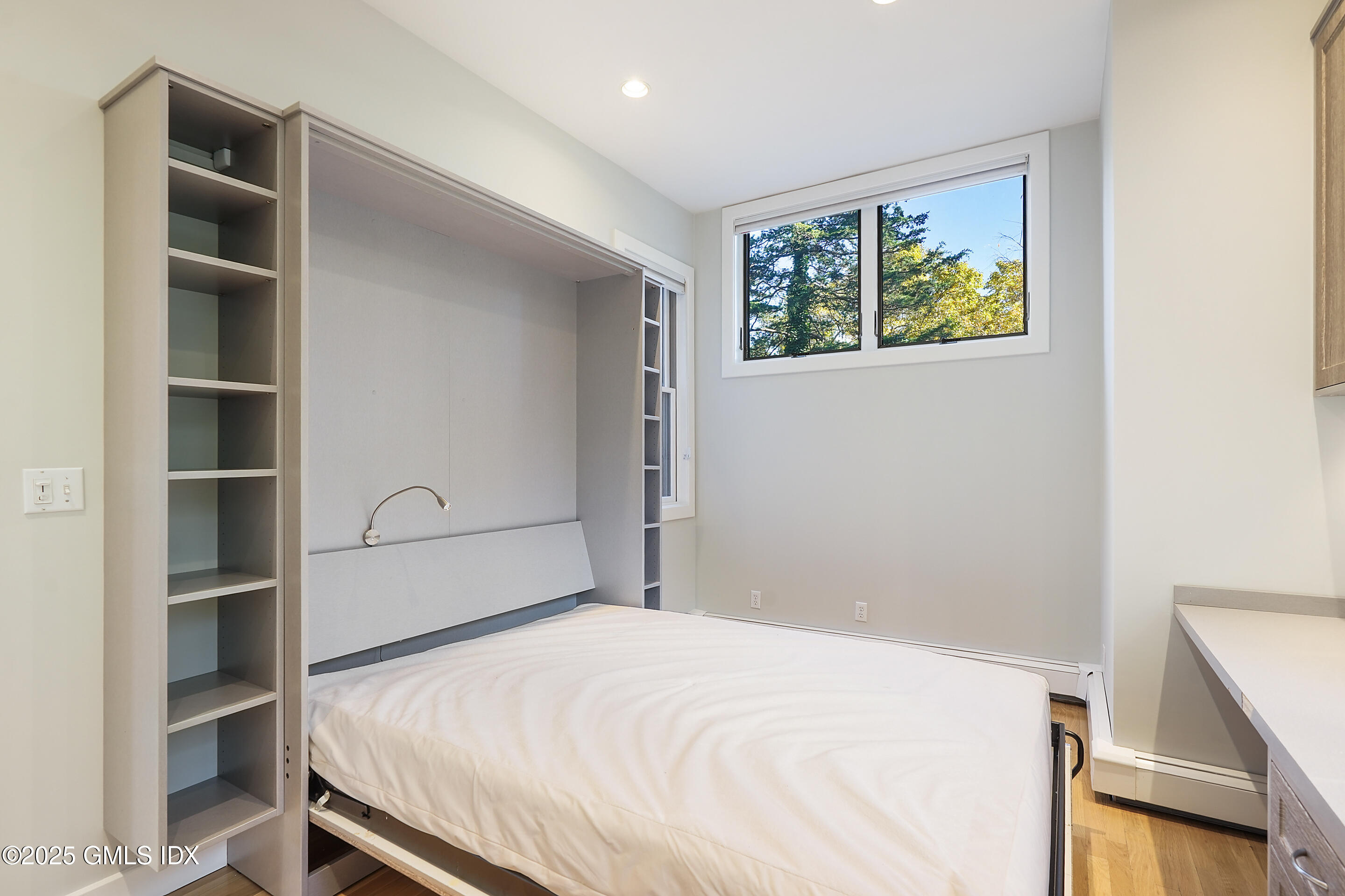 249 Shore Road Greenwich, CT 06830 - Photo 13 of 38 a bedroom with a bed and a window