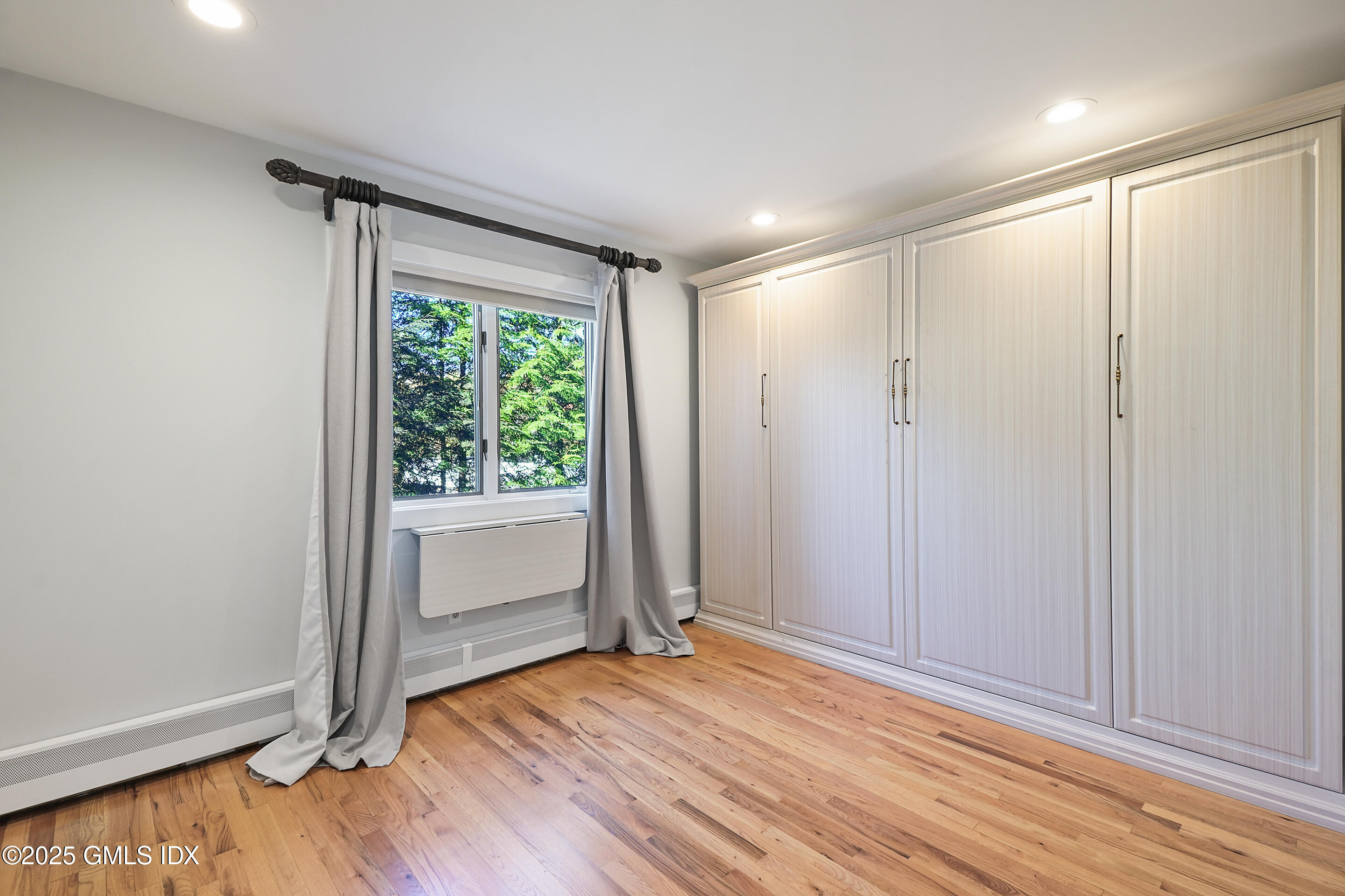 249 Shore Road Greenwich, CT 06830 - Photo 14 of 38 a view of empty room with wooden floor and fan