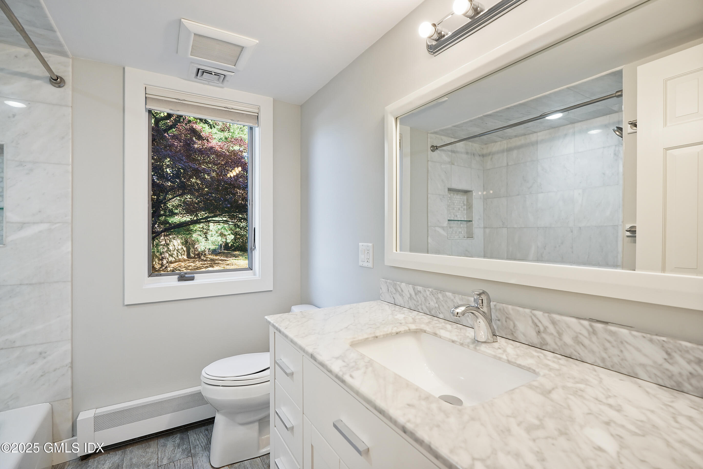 249 Shore Road Greenwich, CT 06830 - Photo 15 of 38 a bathroom with a granite countertop sink toilet and shower