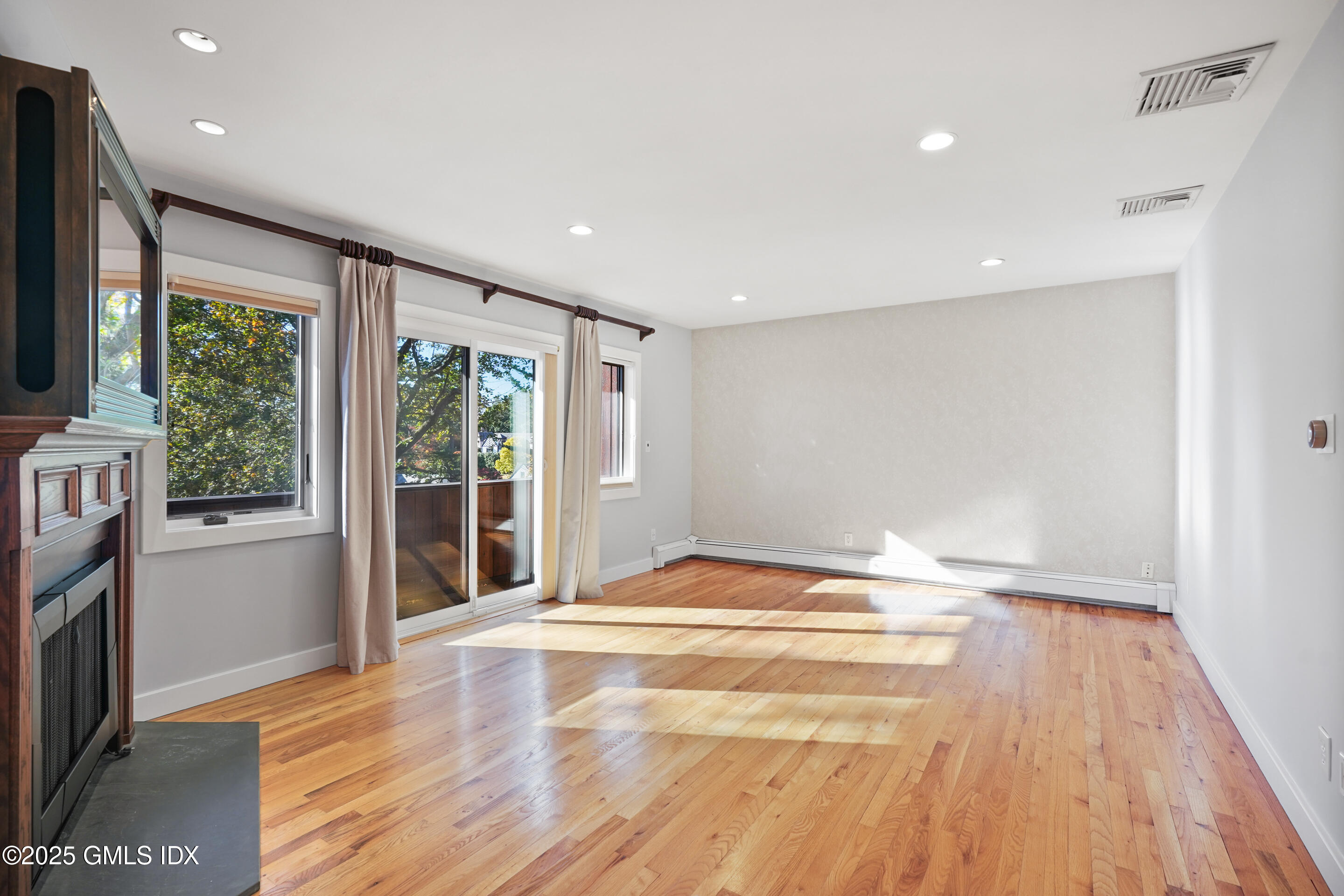 249 Shore Road Greenwich, CT 06830 - Photo 18 of 38 a view of empty room with wooden floor and fan