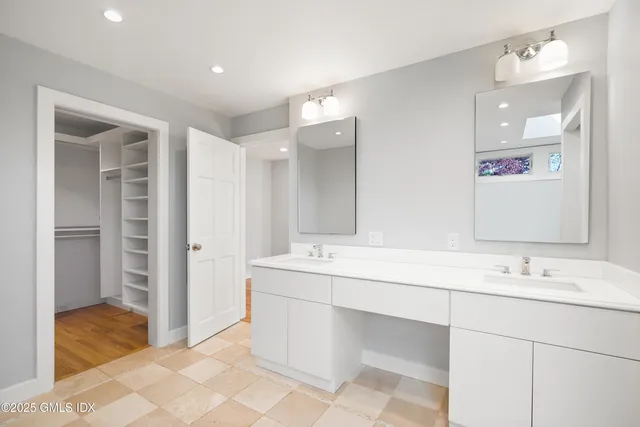 a bathroom with a sink tub and a mirror