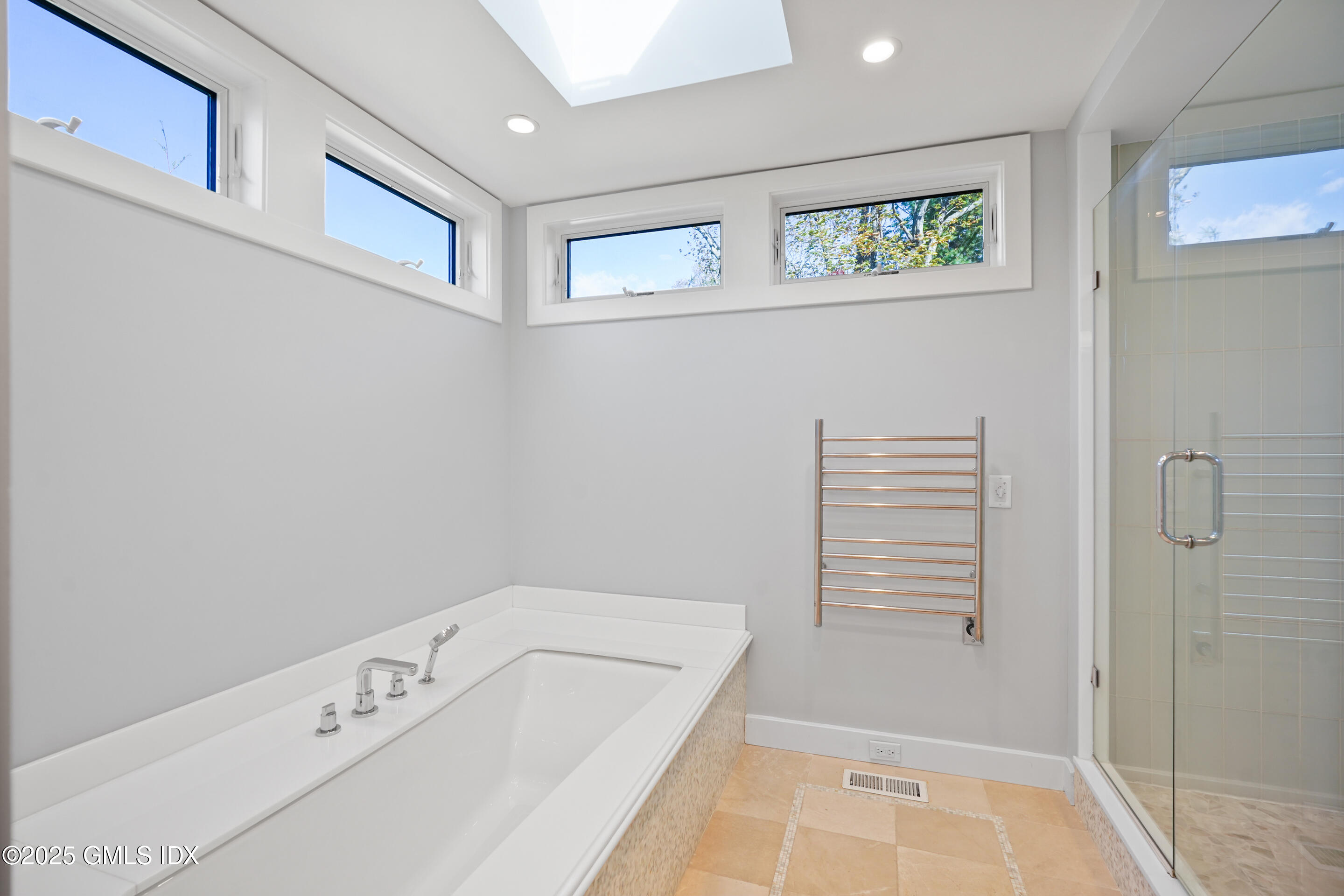 249 Shore Road Greenwich, CT 06830 - Photo 20 of 38 a bathroom with a tub a window and the shower