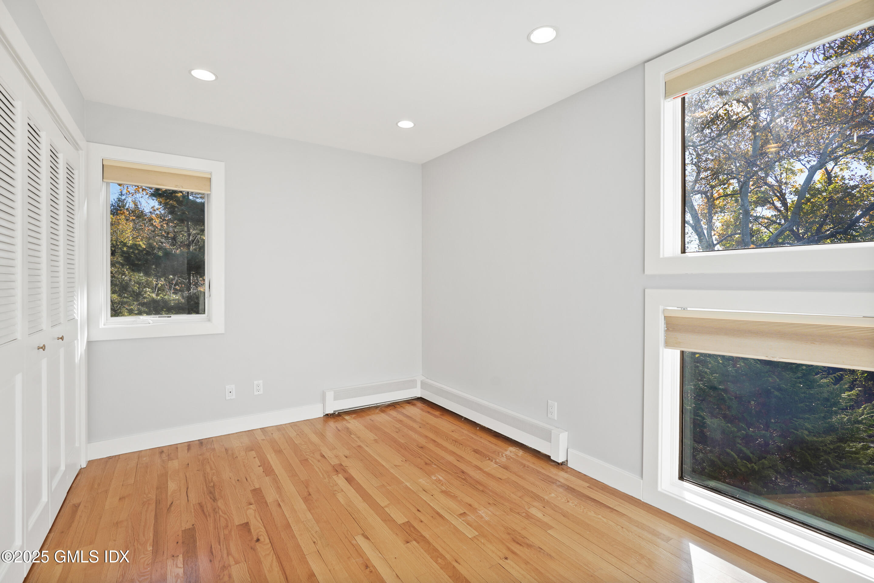249 Shore Road Greenwich, CT 06830 - Photo 23 of 38 a view of empty room with wooden floor and fan