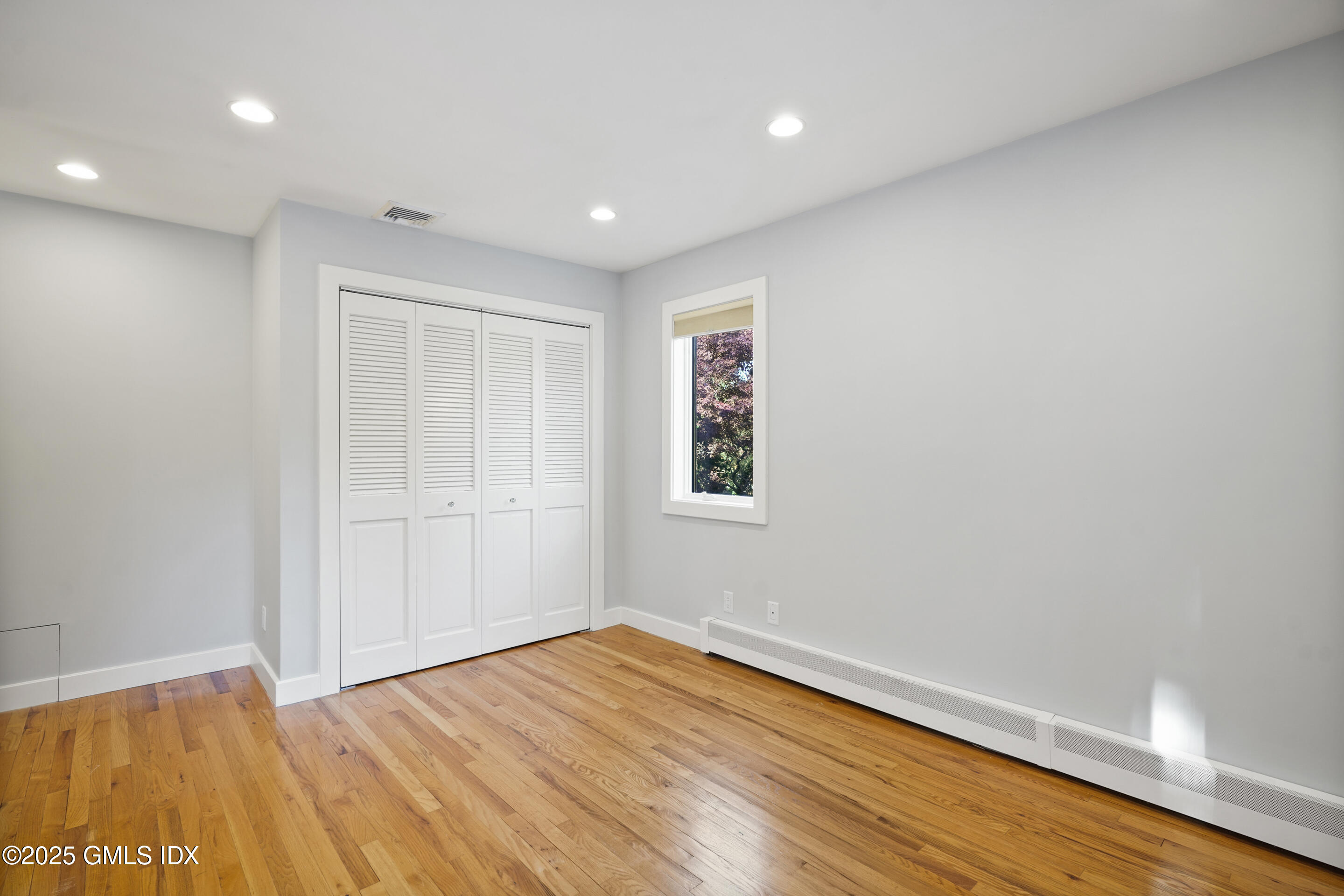 249 Shore Road Greenwich, CT 06830 - Photo 26 of 38 a view of empty room with wooden floor and fan