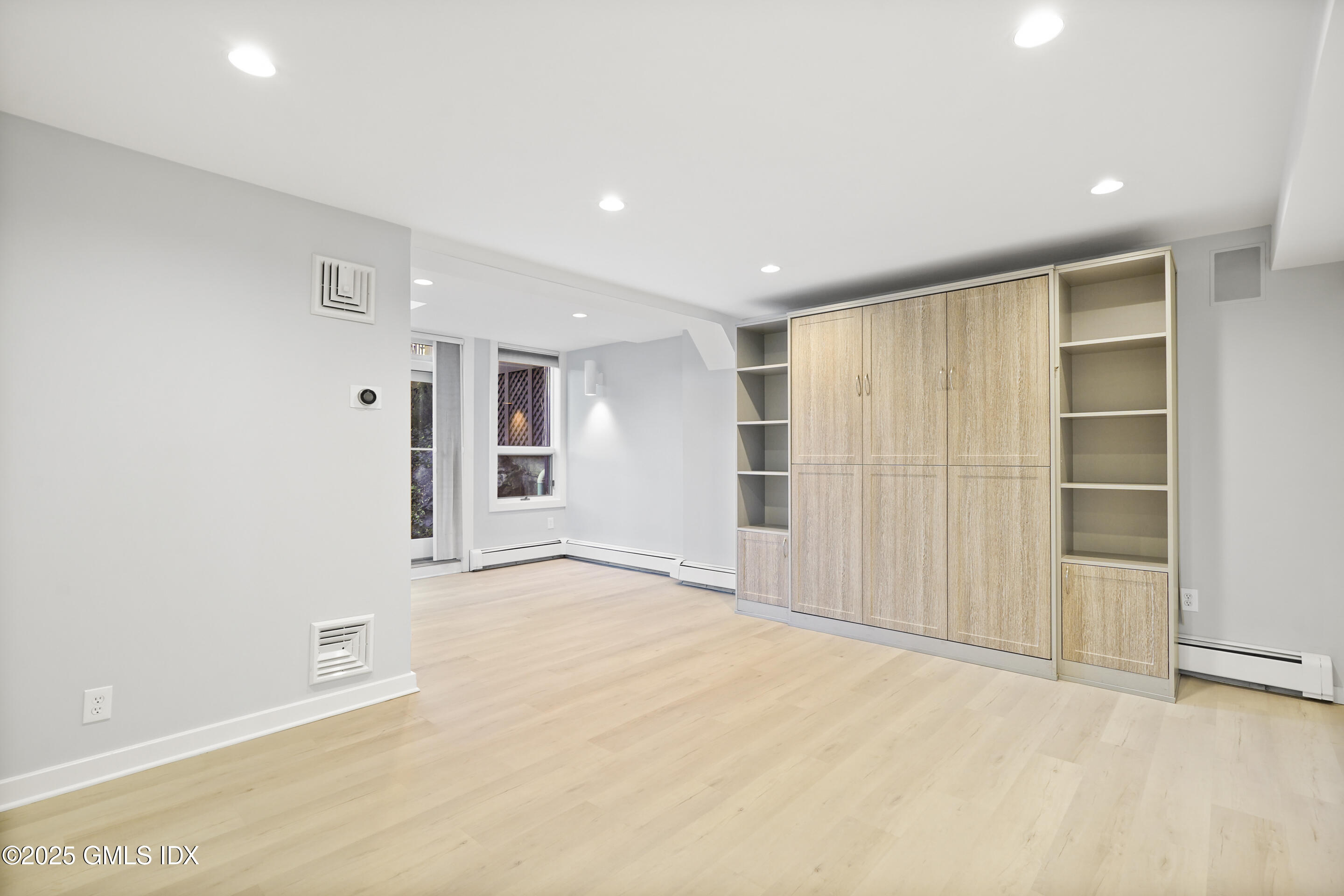 249 Shore Road Greenwich, CT 06830 - Photo 29 of 38 an empty room with cabinet and mirrors