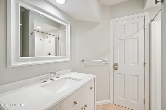 a bathroom with a sink vanity and mirror