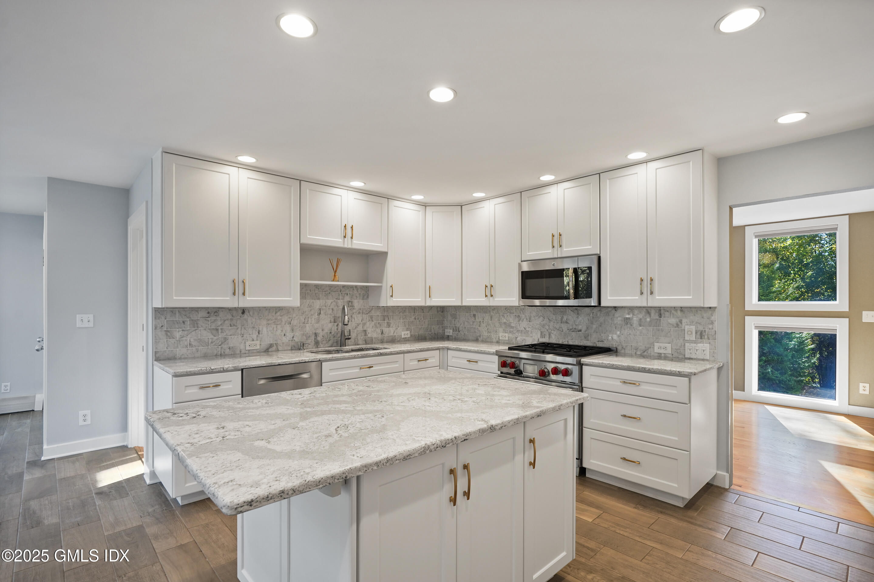 249 Shore Road Greenwich, CT 06830 - Photo 3 of 38 a kitchen with a stove a sink a microwave a counter and cabinets