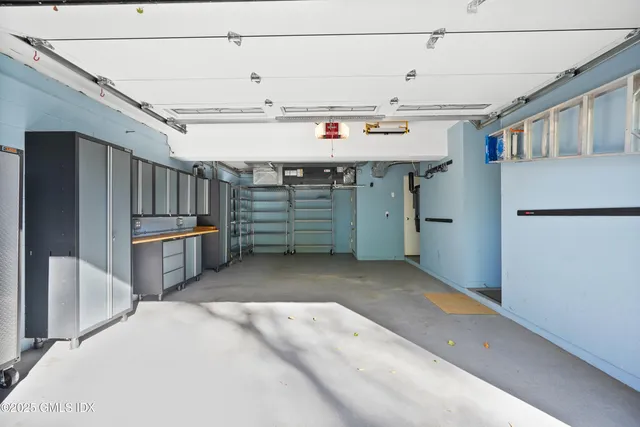 a view of a kitchen with refrigerator and windows